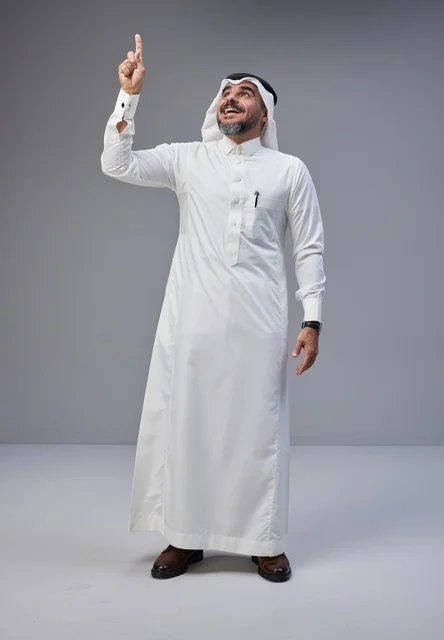 Saudi Man in Traditional Thobe Pointing Upwards