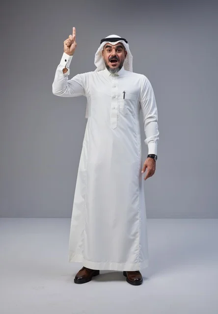 رجل سعودي بالزي التقليدي يشير للأعلى بتعبير مندهش