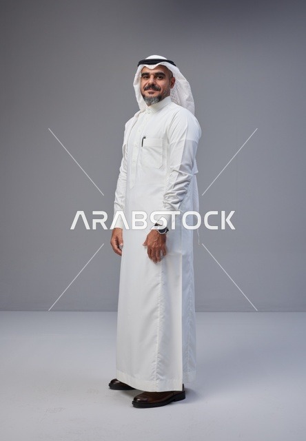 رجل سعودي بالزي التقليدي على خلفية رمادية
