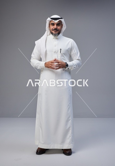 Saudi Man in Traditional Thobe on Gray Background