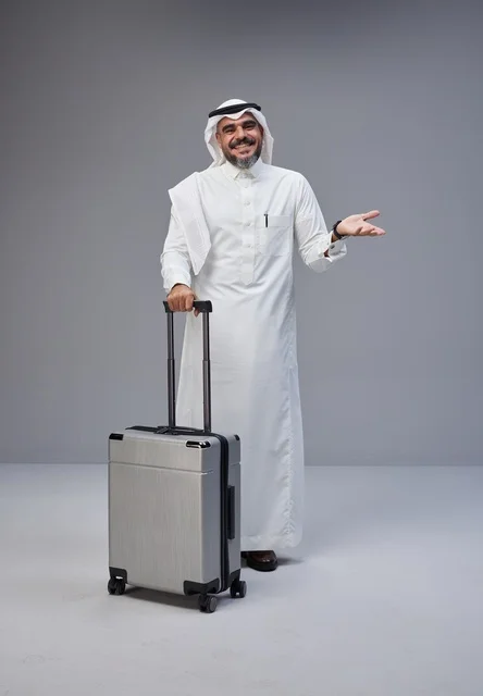 Saudi Man in Traditional Thobe with Travel Suitcase
