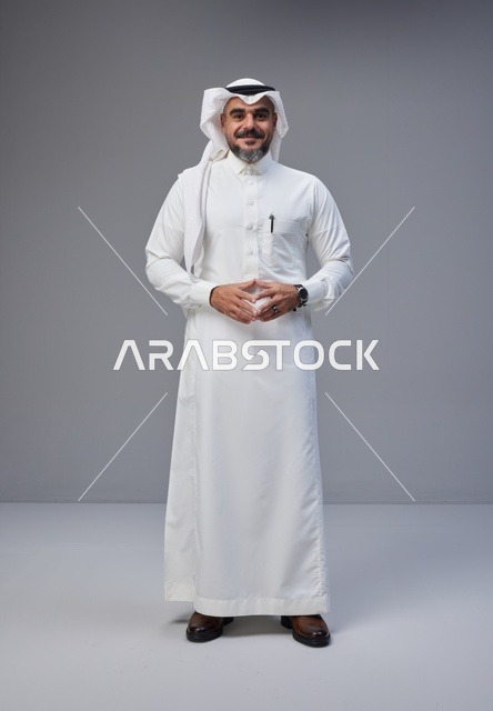 Saudi Man in Traditional Thobe on Gray Background
