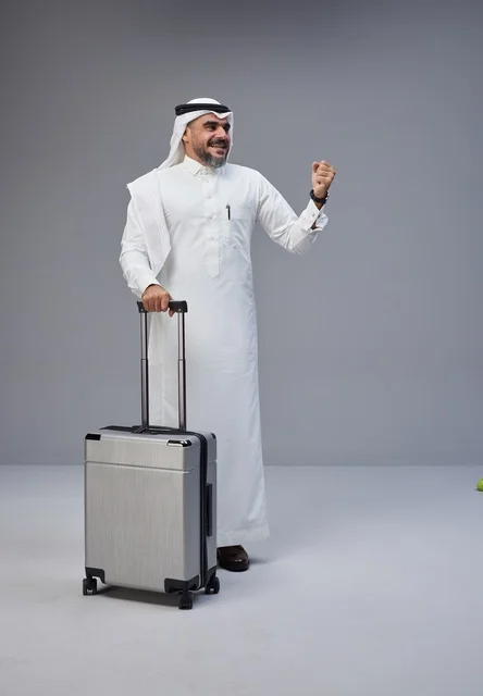 Saudi Man with Travel Suitcase in Studio Setting