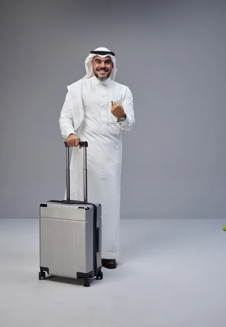 Saudi Man in Traditional Dress with Suitcase