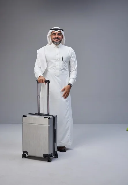 Saudi Man in Traditional Dress with Suitcase