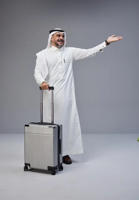 Saudi Man in Traditional Thobe with Travel Suitcase