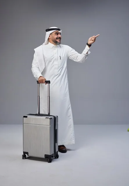 Saudi Man in Traditional Dress with Suitcase