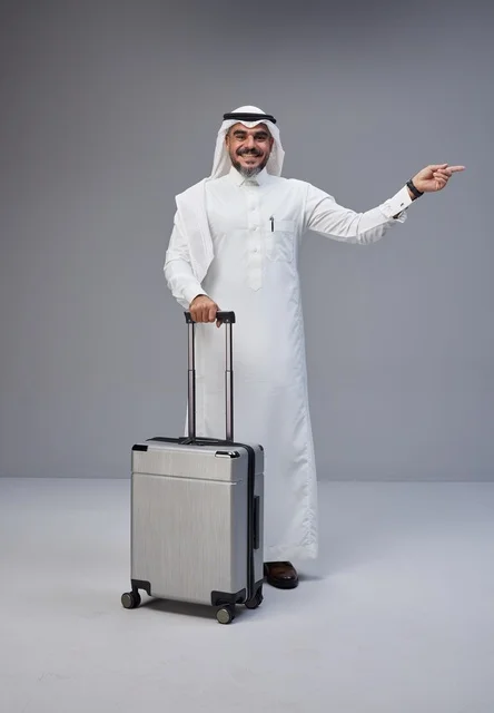 Saudi Man in Traditional Thobe with Suitcase