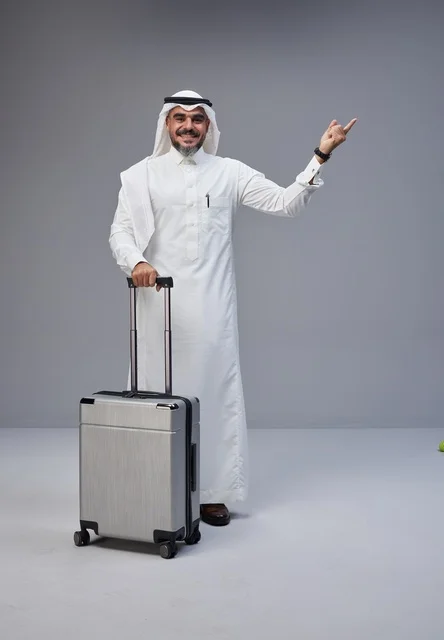Saudi Man in Traditional Thobe with Suitcase