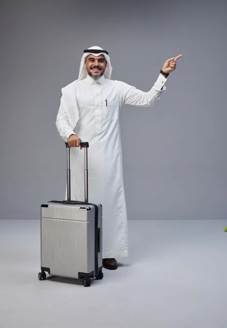 Saudi Man in Traditional Thobe with Suitcase Pointing Up