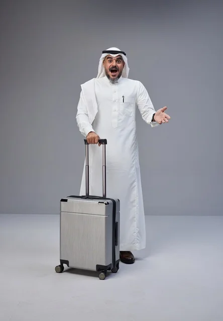 Saudi Man in Traditional Thobe with Suitcase