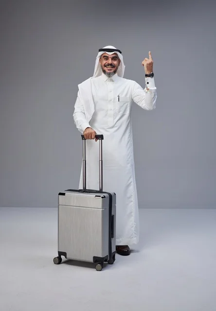 Saudi Man in Traditional Thobe with Suitcase