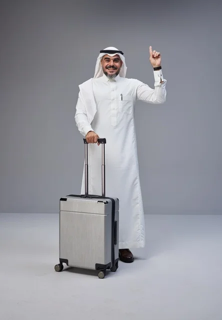 Saudi Man in Traditional Dress with Travel Suitcase