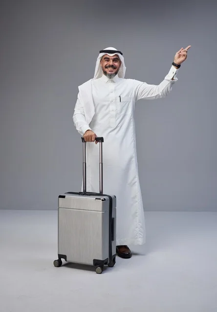 Saudi Man in Traditional Thobe with Travel Suitcase
