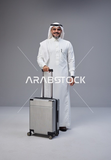Saudi Man in Traditional Thobe with Silver Suitcase