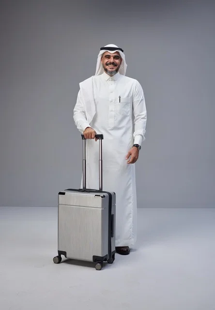 رجل سعودي بالزي التقليدي مع حقيبة سفر