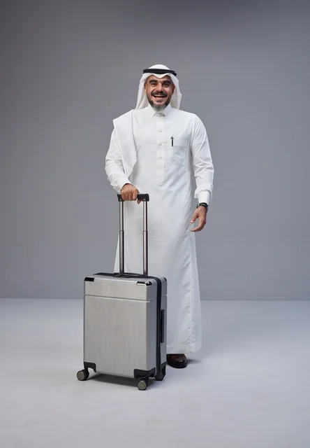 Saudi Man in Traditional Dress with Travel Suitcase
