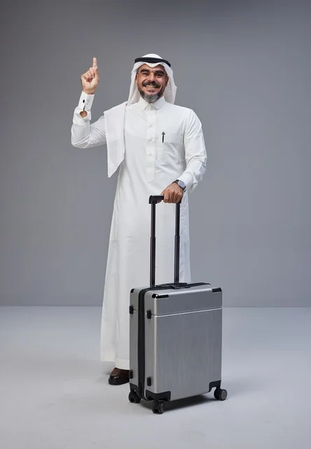 Saudi Man in Traditional Dress with Travel Suitcase