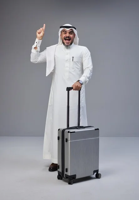 Saudi Man in Traditional Dress with Travel Suitcase