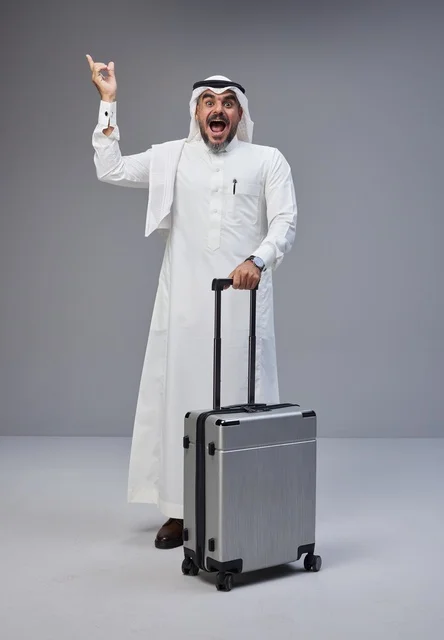 Saudi Man in Traditional Dress with Suitcase