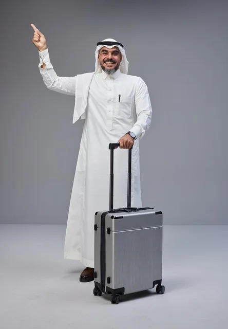 Saudi Man in Traditional Dress with Suitcase