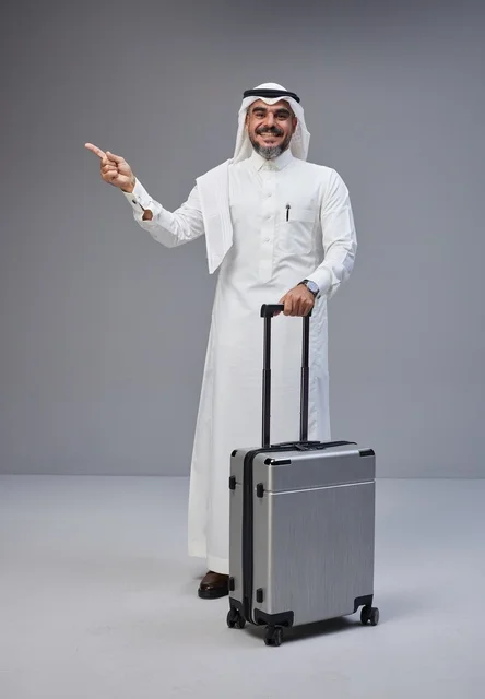 Saudi Man in Traditional Dress with Travel Suitcase