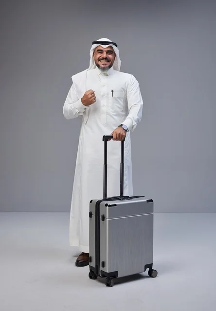Saudi Man in Traditional Dress with Suitcase