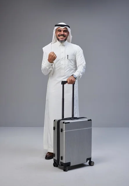Saudi Man in Traditional Dress with Suitcase Saudi Man in Traditional Dress with Suitcase