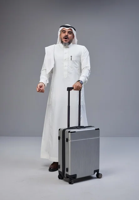 رجل سعودي مع حقيبة سفر بتعبيرات مندهشة