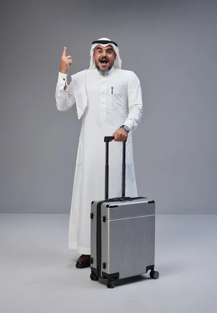 Saudi Man with Travel Suitcase Pointing Up in Studio