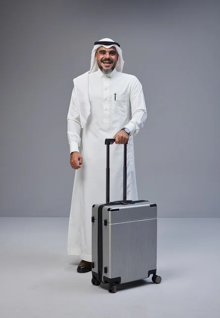 Saudi Man in Traditional Dress with Travel Suitcase