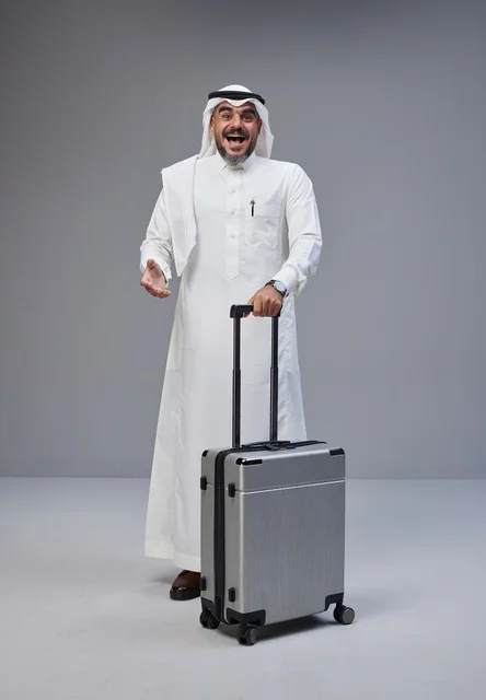 Saudi Man in Traditional Dress with Travel Suitcase