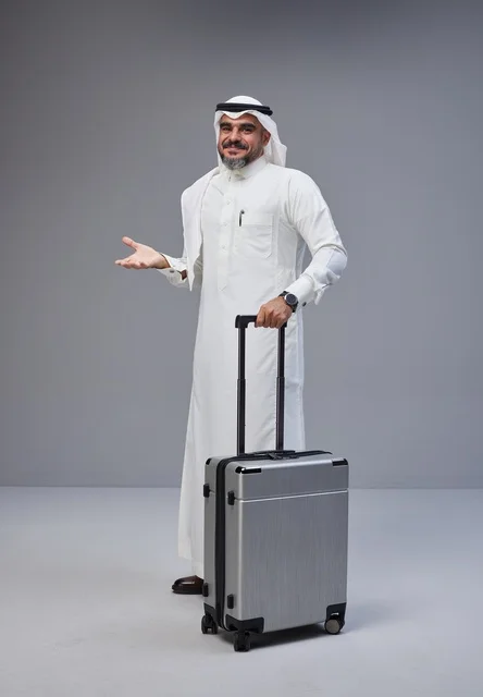 Saudi Man in Traditional Attire with Suitcase