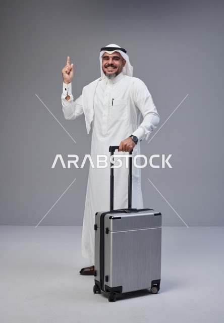 Saudi Man in Traditional Thobe with Silver Suitcase