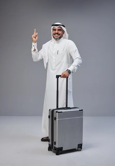 Saudi Man in Traditional Thobe with Silver Suitcase
