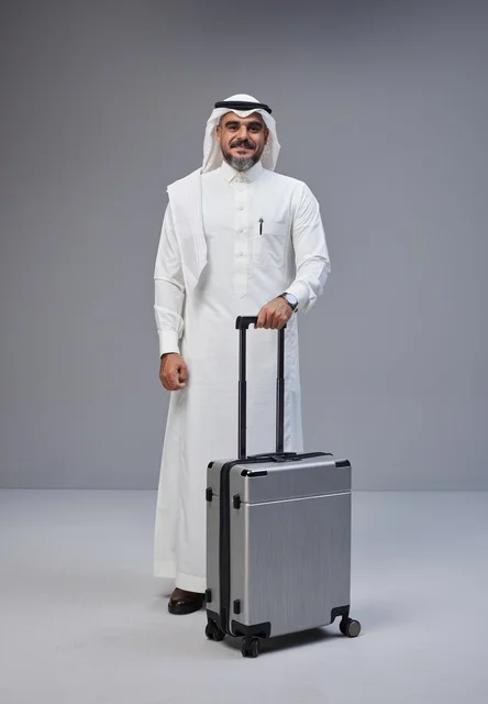 Saudi Man in Traditional Dress with Travel Suitcase