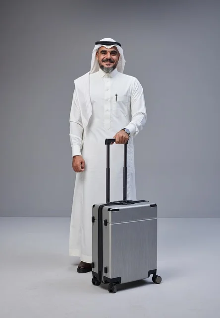 Saudi Man in Traditional Dress with Suitcase