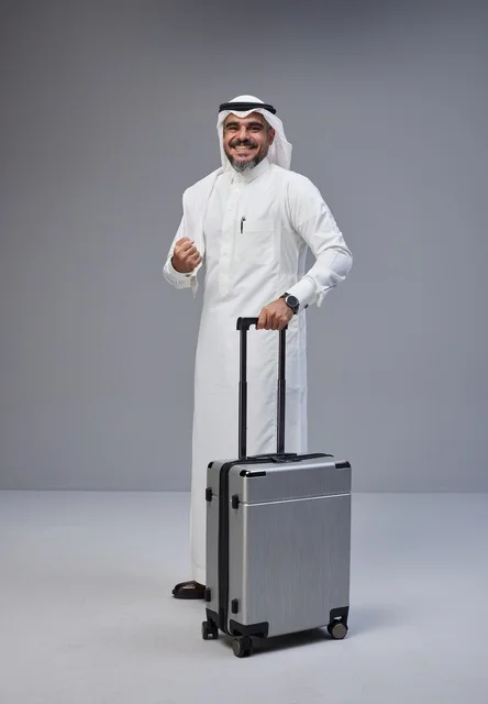 Saudi Man in Traditional Dress with Travel Suitcase