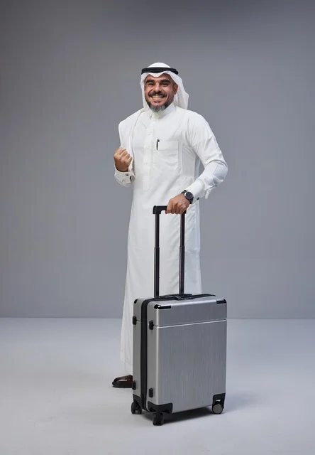 Saudi Man in Traditional Thobe with Travel Suitcase