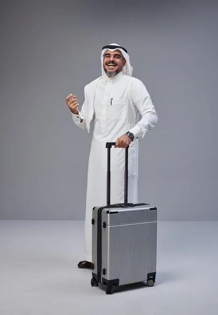 Saudi Man in Traditional Thobe with Travel Suitcase