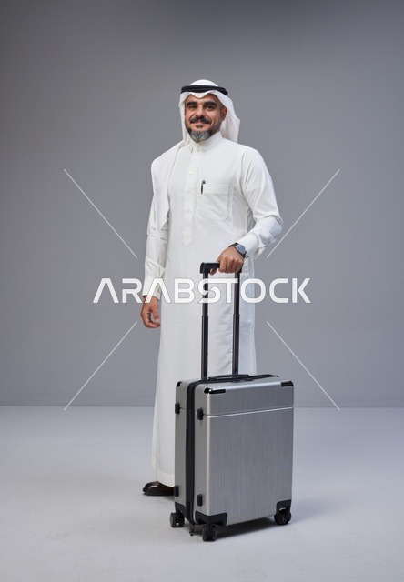 Saudi Man in Traditional Thobe with Silver Suitcase