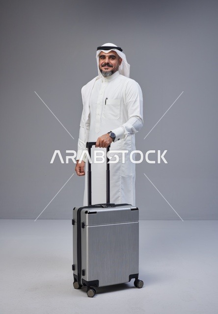 Saudi Man in Traditional Thobe with Travel Suitcase
