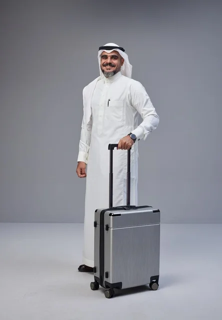Saudi Man in Traditional Dress with Suitcase