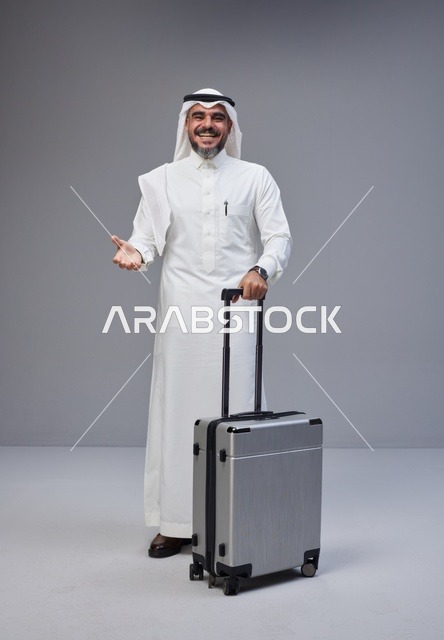 Saudi Man in Traditional Thobe with Silver Suitcase