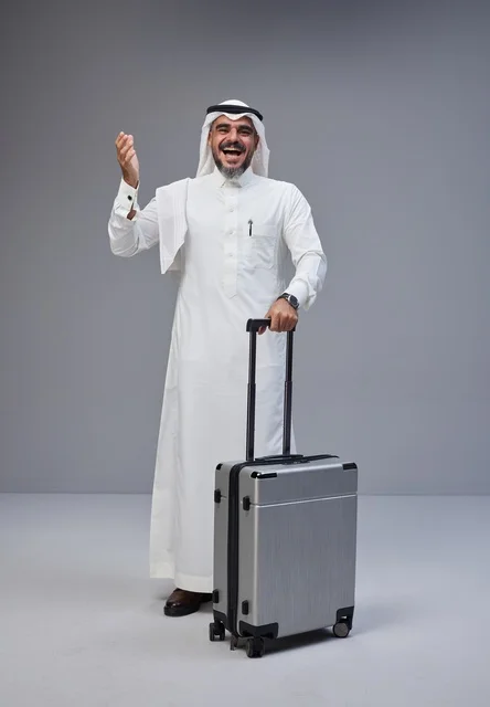 Saudi Man in Traditional Dress with Suitcase