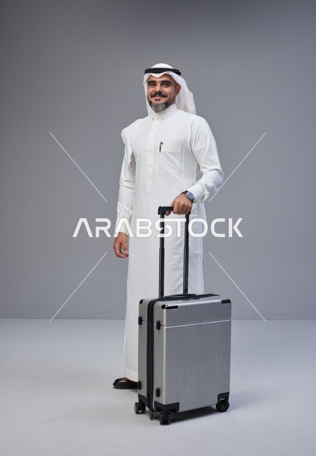 Saudi Man in Traditional Thobe Holding Suitcase