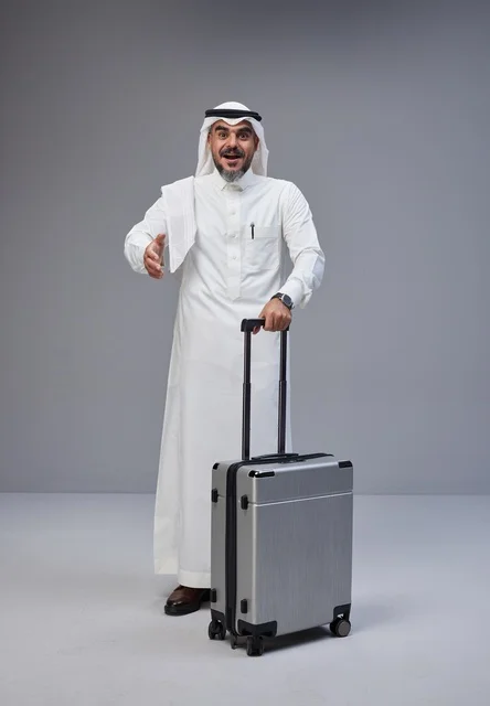 Saudi Man in Traditional Thobe with Silver Suitcase