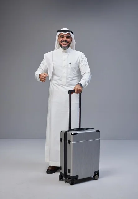 Saudi Man in Traditional Dress with Travel Suitcase