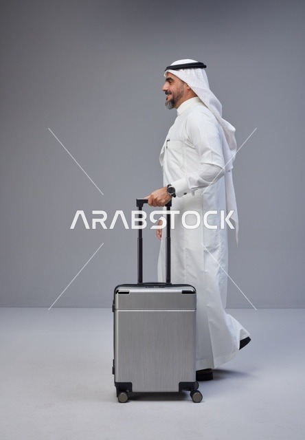 Saudi Man Walking with Suitcase in Studio