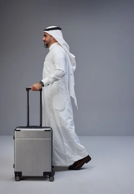 Saudi Man in Traditional Thobe with Suitcase